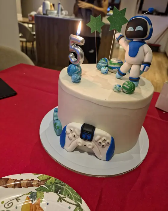 Bolo de 5 anos com astronauta, planetas e comando de consola em pasta de açúcar